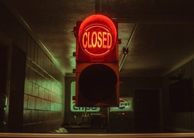 Closed sign at night at a local mechanic shop