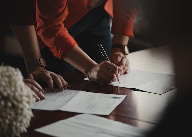 People signing documents