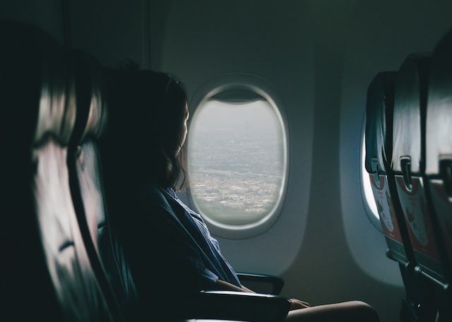 Woman by an airplane window