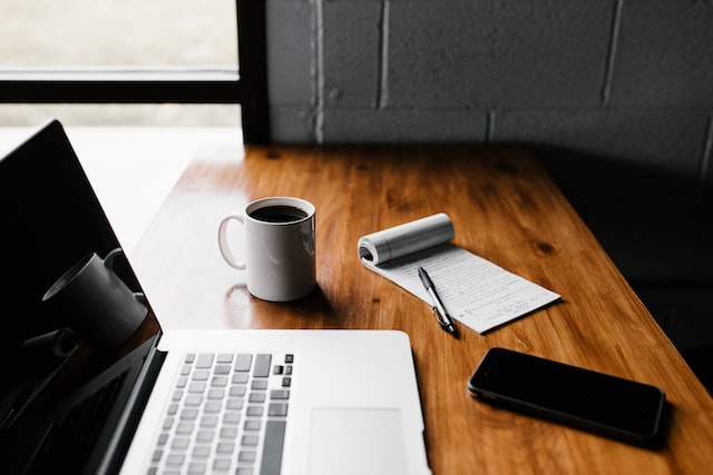 coffee laptop and phone are on the table