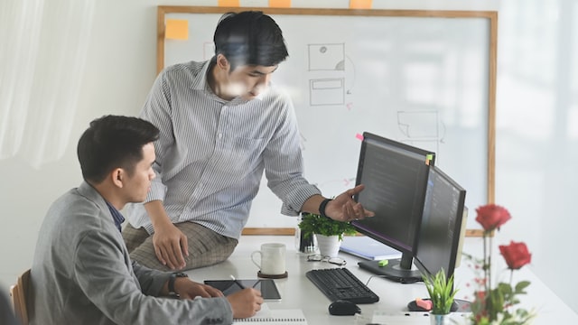 man helping his employee at work