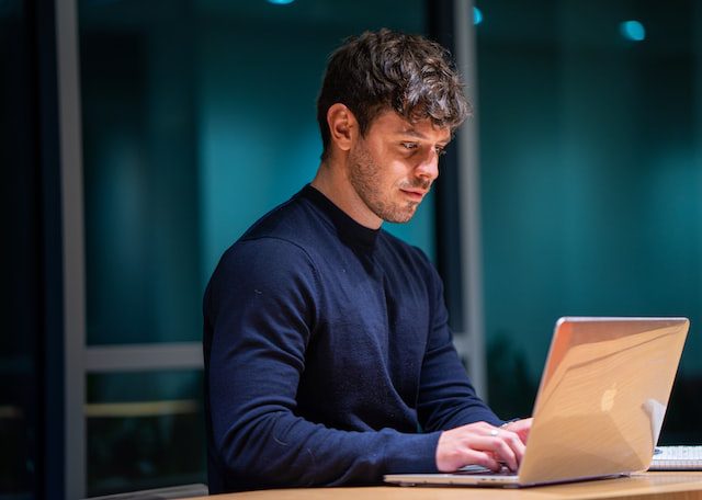 man working on computer in the evening