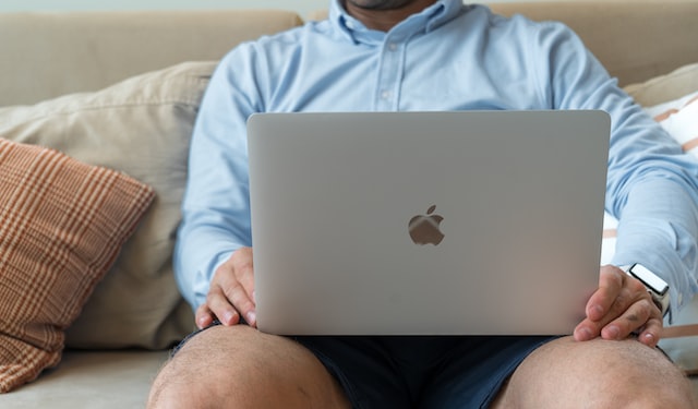 man working on macbook at home