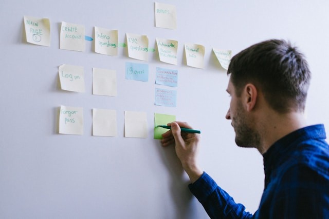 person writing on notes