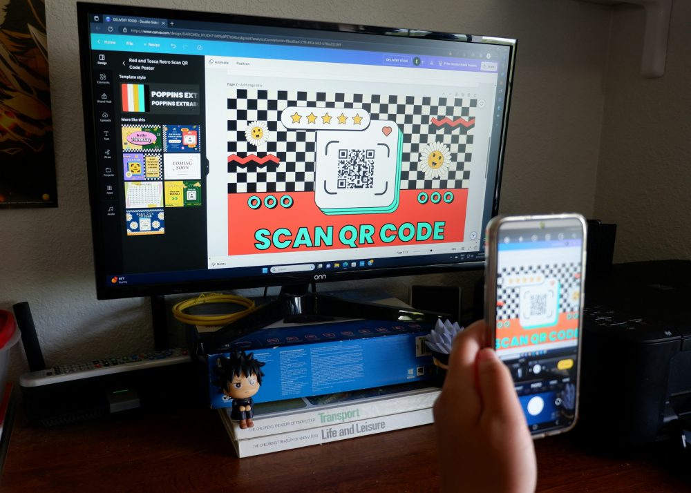 a-person-holding-a-cell-phone-in-front-of-a-computer-screen